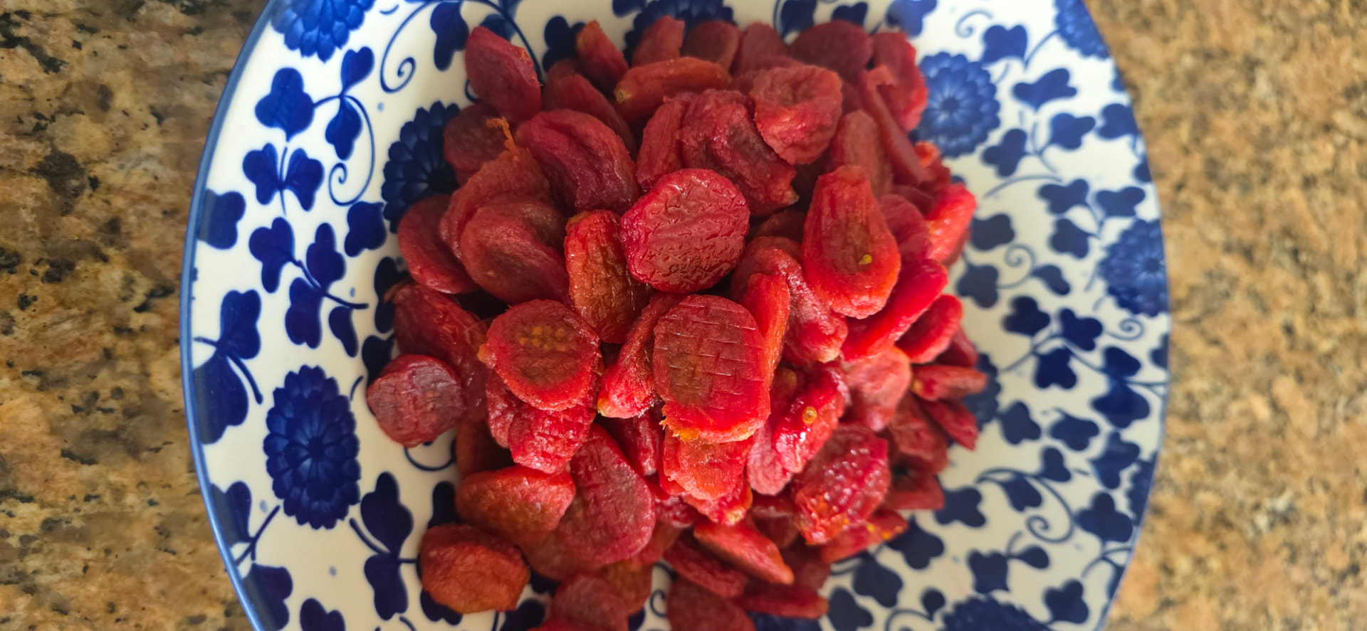 Finished NAKED grape tomato raisins served in a blue and white bowl
